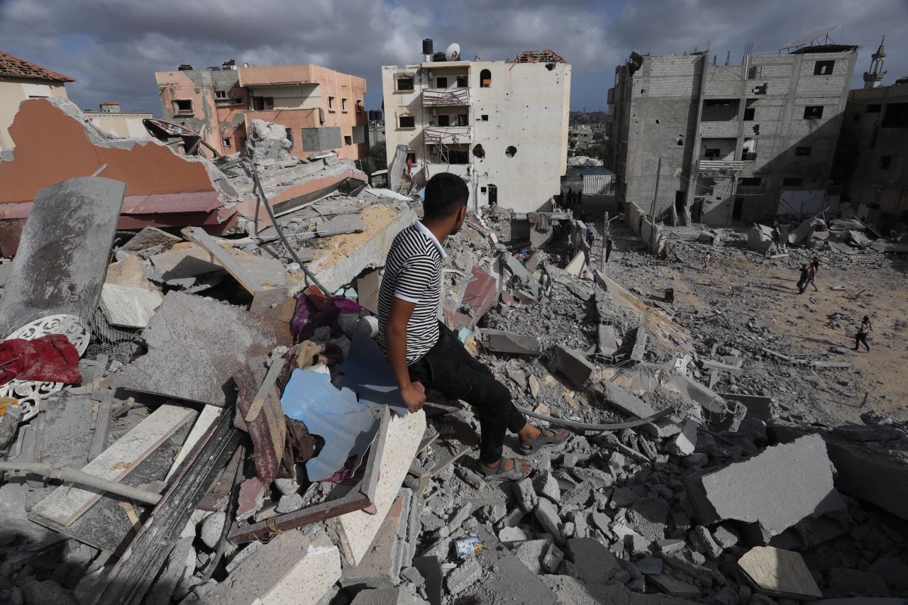 A man sits amid rubble of a destroyed building following Israeli attacks on the al-Salam neighborhood of Rafah on May 5. 