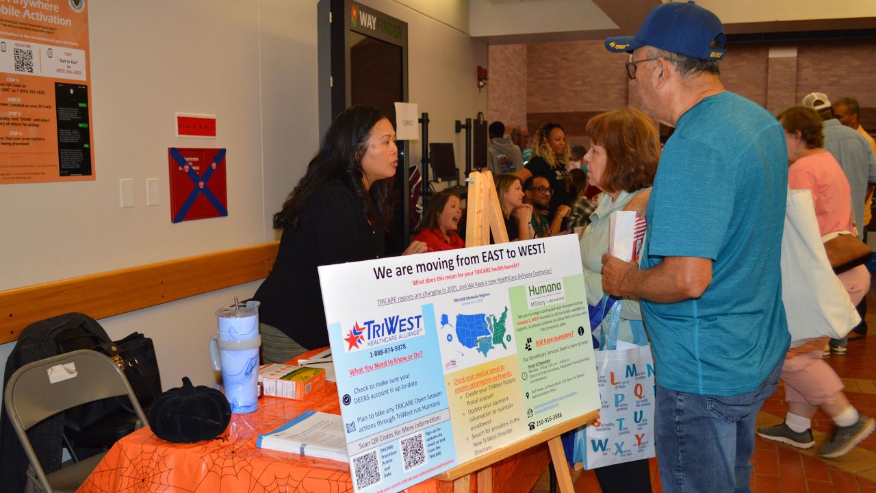Anh Hoang, left, from Managed Care, Beneficiary Services, talks to retirees about Texas moving from the TRICARE East to the TRICARE West region in 2025 during the Joint Base San Antonio Military Retiree Appreciation Day at Brooke Army Medical Center, JBSA-Fort Sam Houston, Texas, Oct. 19, 2024. The annual event featured more than 80 services, with representatives available to provide health screenings, information, and activities. (DoD Photo by Lori Newman)