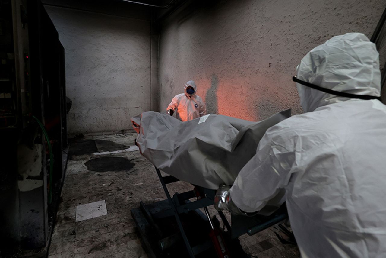 Crematorium workers place the body of a person who died of COVID-19 into the oven to be cremated at the San Isidro Crematorium in Azcapotzalco,  on Wednesday, July 15,  in Mexico City.