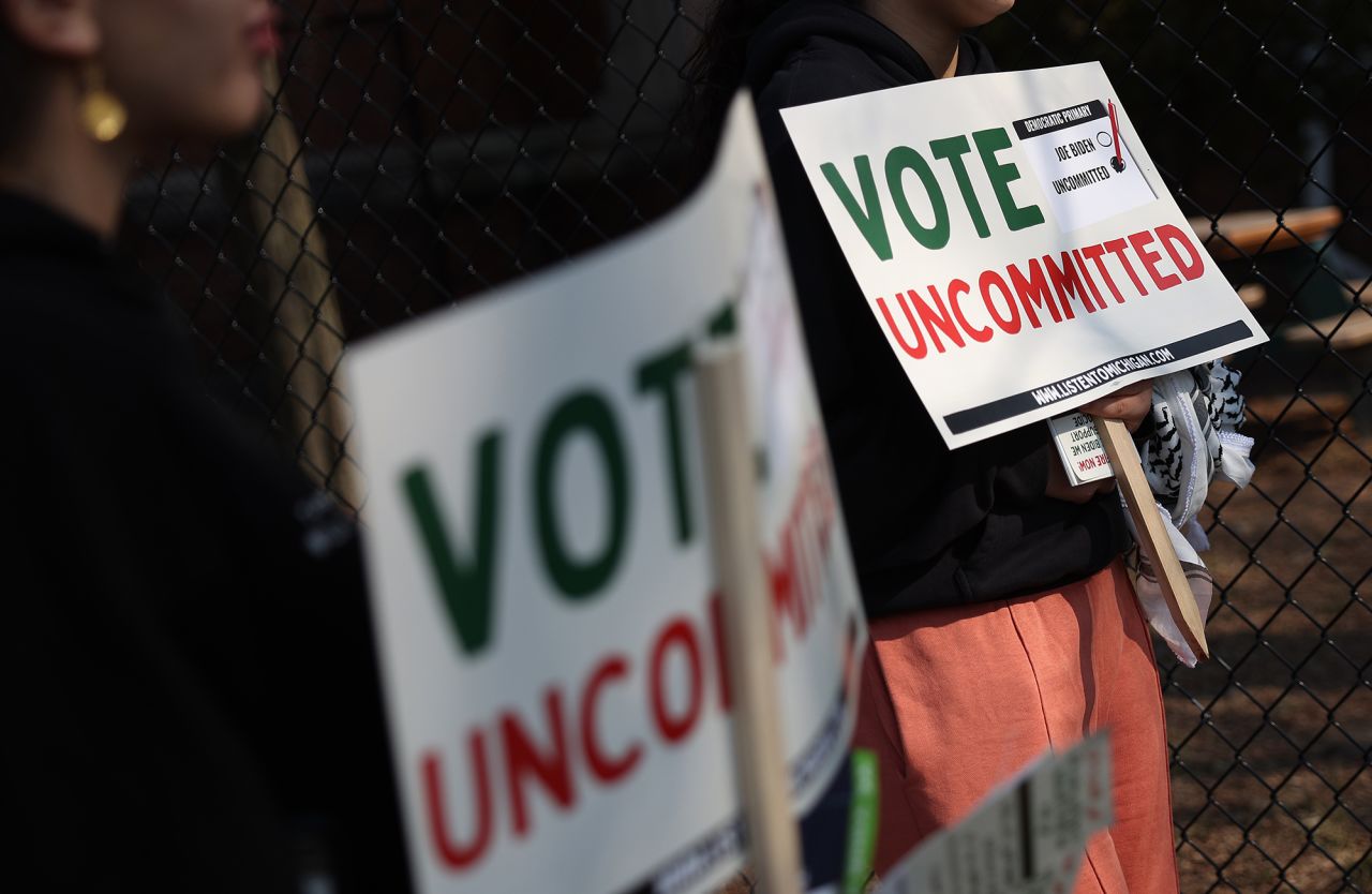 Demonstrators hold signs urging people to vote uncommitted on February 27, in Dearborn, Michigan. 