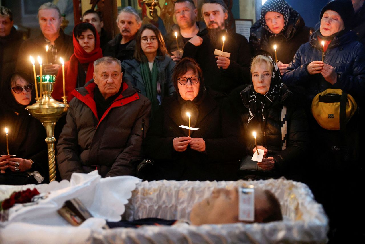 Alexey Navalny's open casket lies in front his parents Lyudmila Navalnaya, center, and Anatoly Navalny, center left, during his funeral service at the Church of the Icon of the Mother of God 'Quench My Sorrows' in Moscow on Friday.