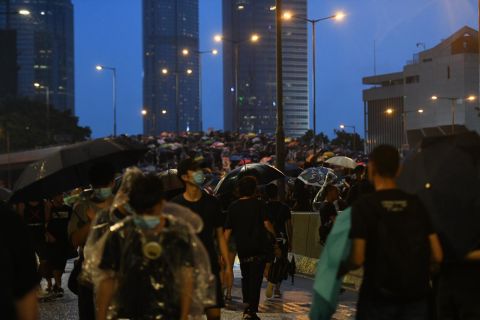 Protesters marching from Wan Chai to Central district as night falls. 