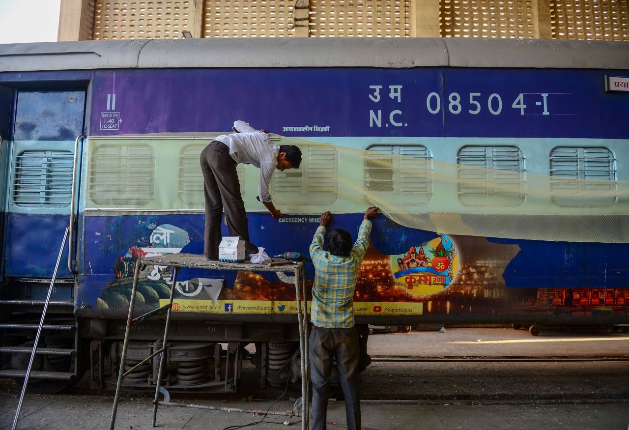 Laborers work on train coaches that will be used as temporary isolation wards in preparation for coronavirus-infected patients at a workshop in Allahabad on April 4, 2020.