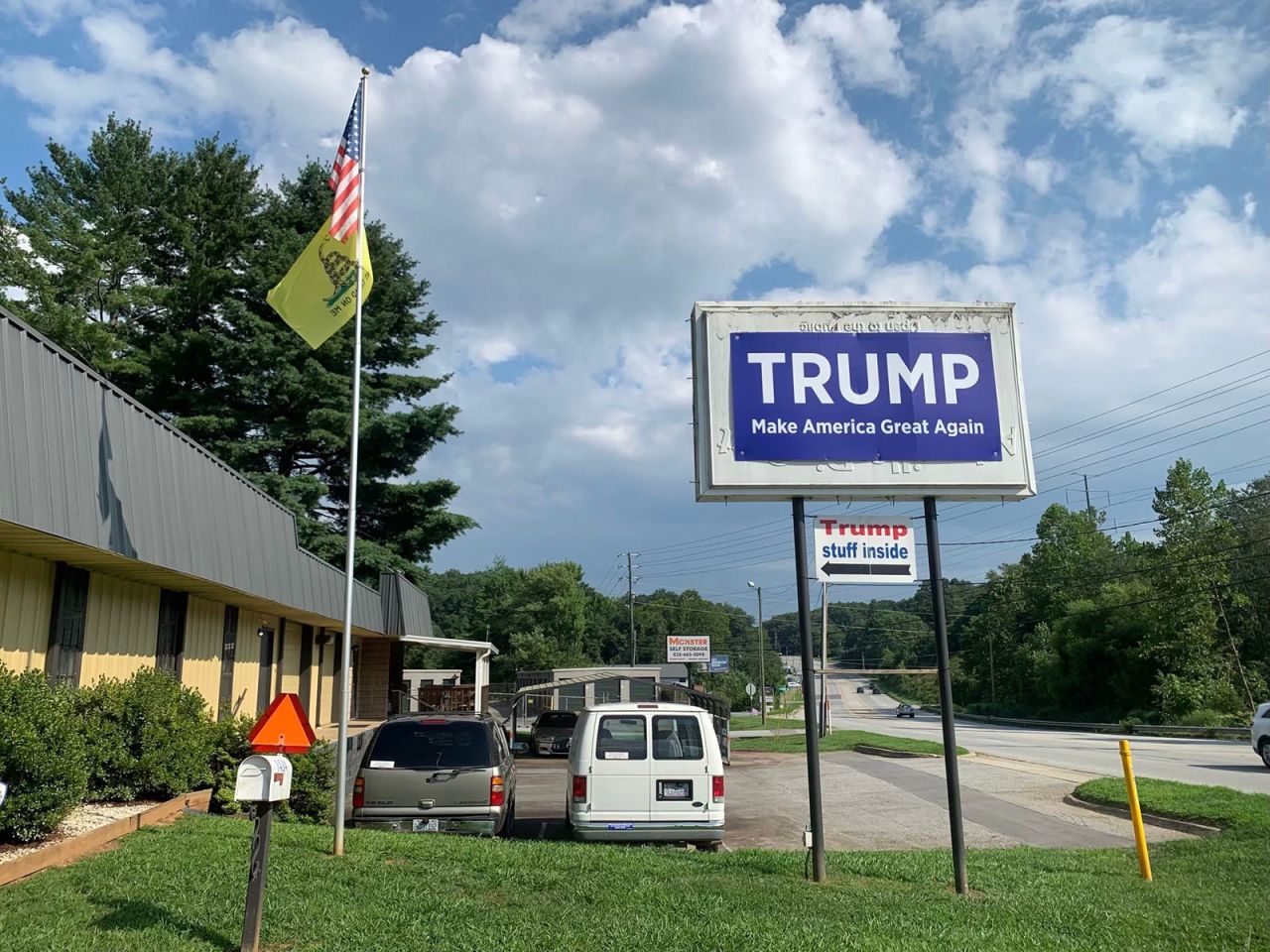 A sign supporting former President Donald Trump hangs from a billboard along Brevard Road near Asheville, North Carolina, on August 11. 