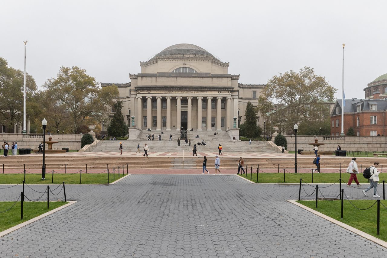 People walk past Columbia University in New York on October 30, 2023. 