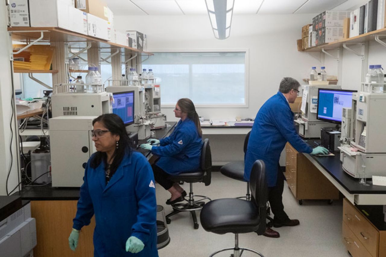 People work in a lab that President Donald Trump watched during his meeting about the coronavirus at the Centers for Disease Control and Prevention, Friday, March 6, in Atlanta. 