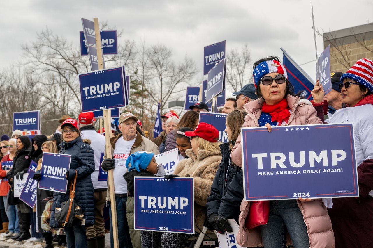 Trump supporters wait together ahead of Republican presidential candidate and former President Donald Trump's visit to the Londonderry High School polling station on January 23.