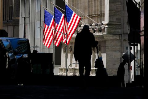 Pedestrians pass the New York Stock Exchange on Wednesday, October 14, in New York.
