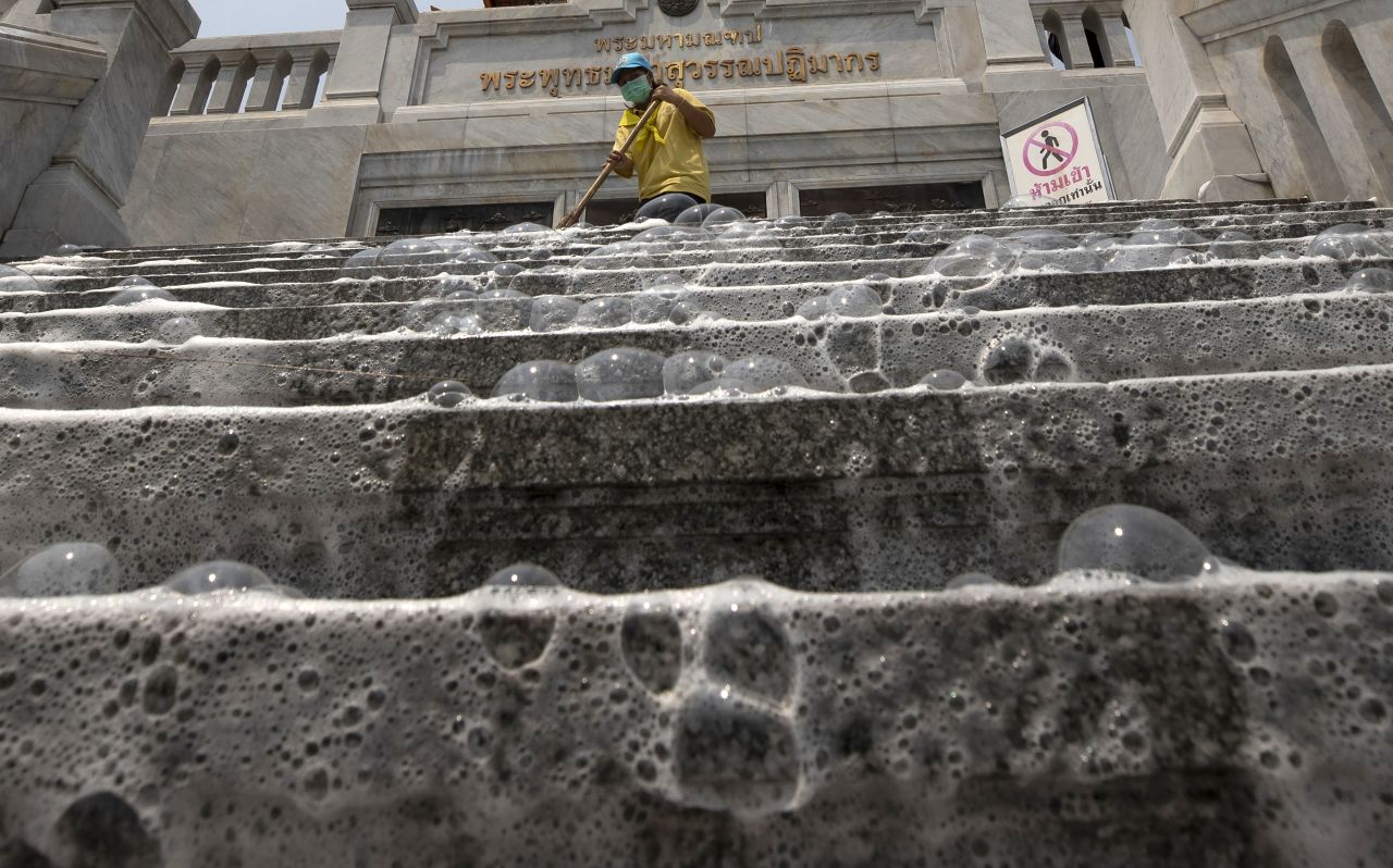 Soap bubbles cover the steps of Wat Taimit Temple as volunteers clean the public areas as a safety precaution against the coronavirus Wednesday, March 18, in Bangkok, Thailand. 