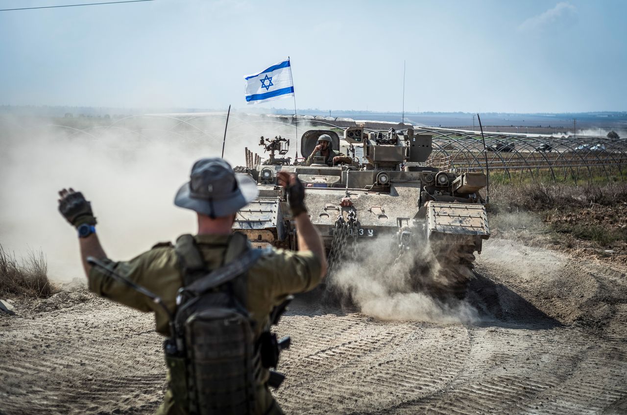 Israeli soldiers and military combat vehicles are seen in Sderot, Israel, near the Gaza border, on October 14.