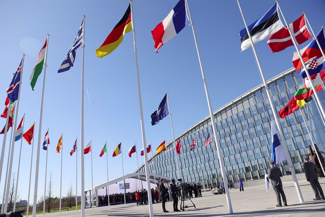 Flags flutter outside the NATO headquarters in Brussels, Belgium, on April 4