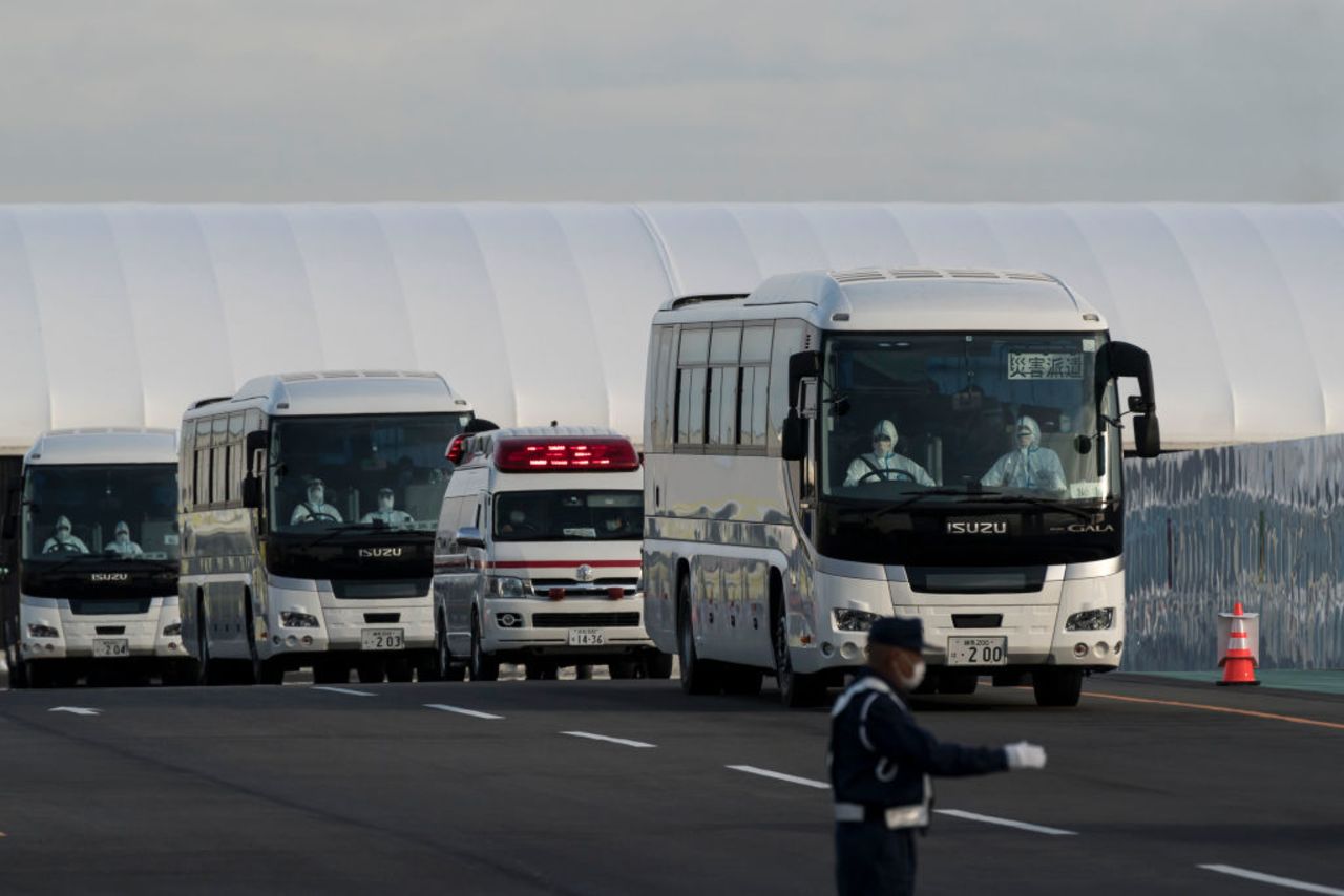 Buses carrying passengers who disembarked the quarantined Diamond Princess cruise ship and emergency vehicles at the Daikoku Pier on February 19, 2020 in Yokohama, Japan.