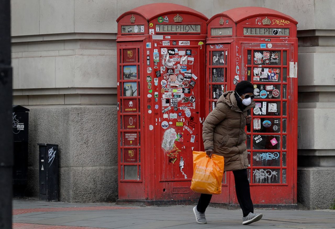 A woman wears a protective mask to protect from coronavirus in central London as Britain continues its lockdown.