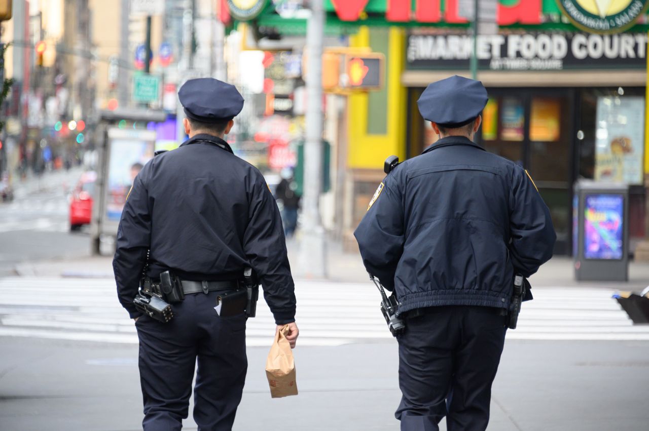 Two NYPD officers walk through Times Square on March 22.