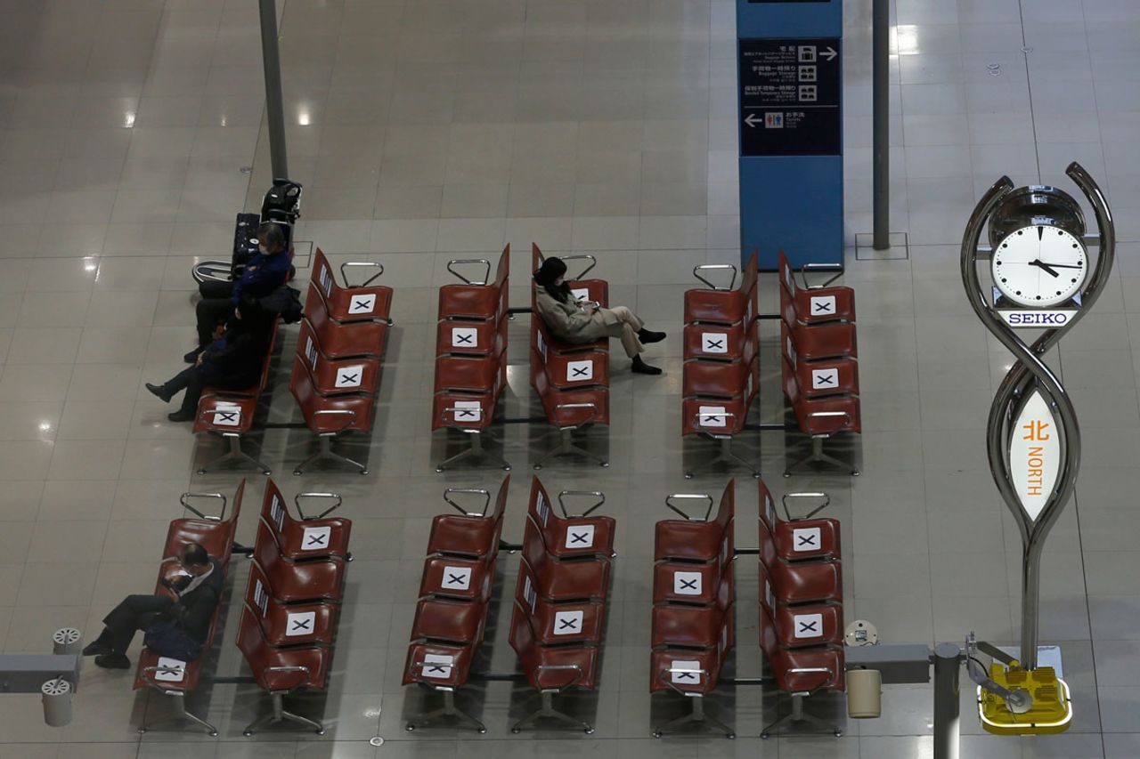 Passengers sit in an almost empty arrival hall at Kansai International Airport on December 27 in Osaka, Japan.