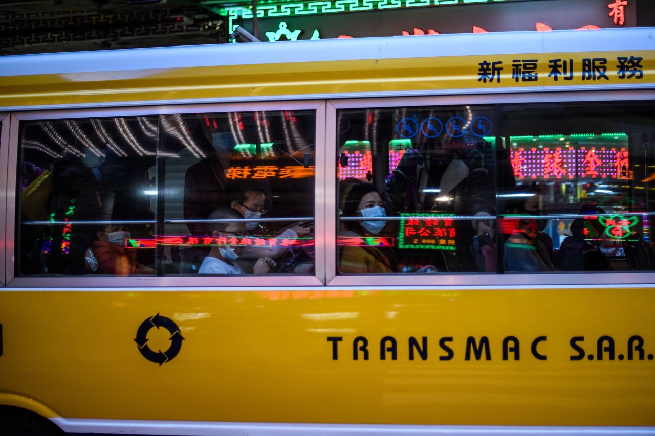 Commuters wear face masks as they travel in a bus in Macau on Wednesday.