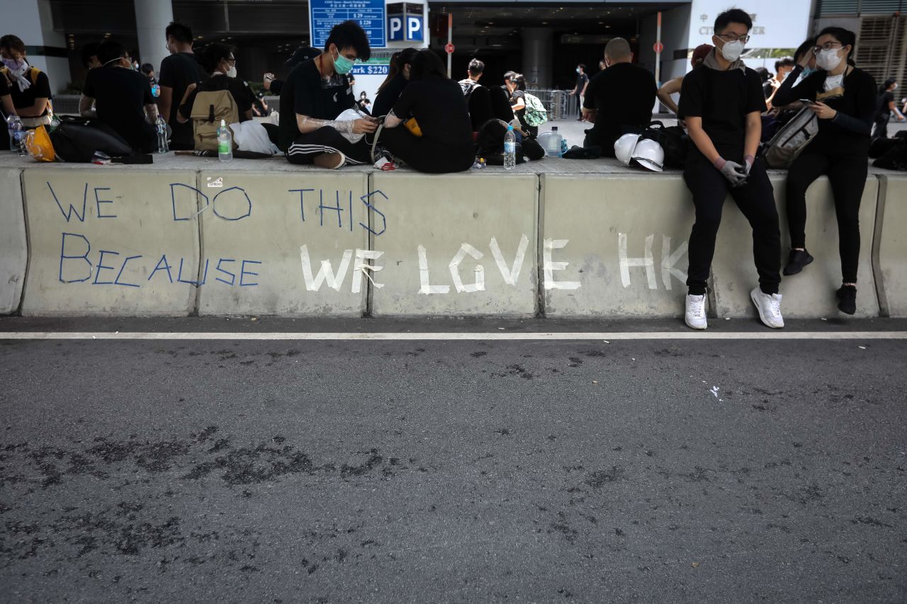 Protesters rest on a road divide outside the Legislative Council in Hong Kong after a flag raising ceremony to mark the 22nd anniversary of the city's handover from Britain to China on July 1.