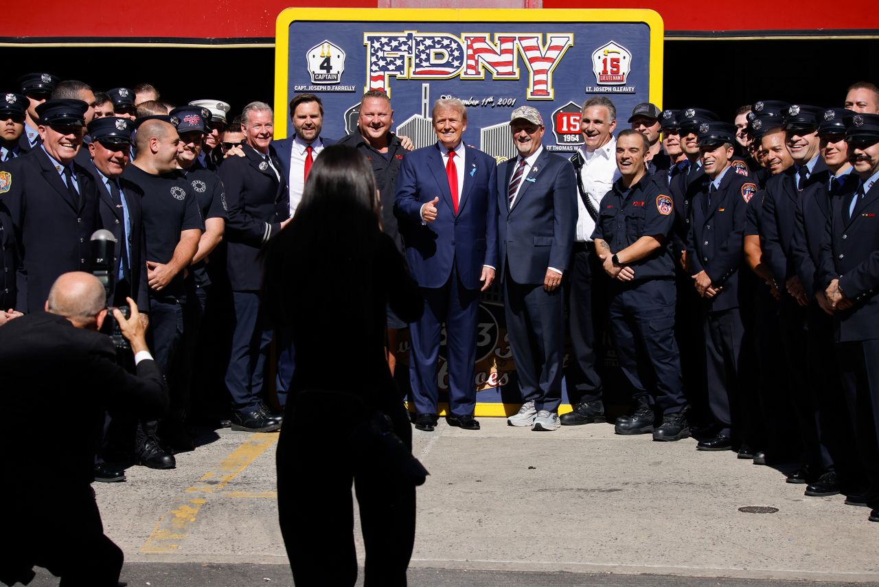 Former President Donald Trump, center and Sen. JD Vance pose for a photo with firefighters from Engine 4 Ladder 15 on the 23rd anniversary of the Sept. 11, 2001 terror attacks on Wednesday in New York.