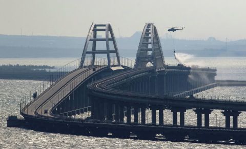A helicopter drops water to extinguish fire on the Kerch bridge in Crimea on October 8. 