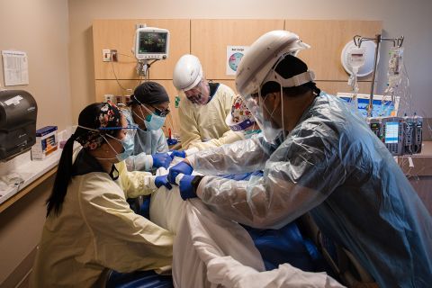 Health care workers prone a patient in the Covid-19 Intensive Care Unit (ICU) overflow area at a hospital in Mission Hills, California, on February 5.
