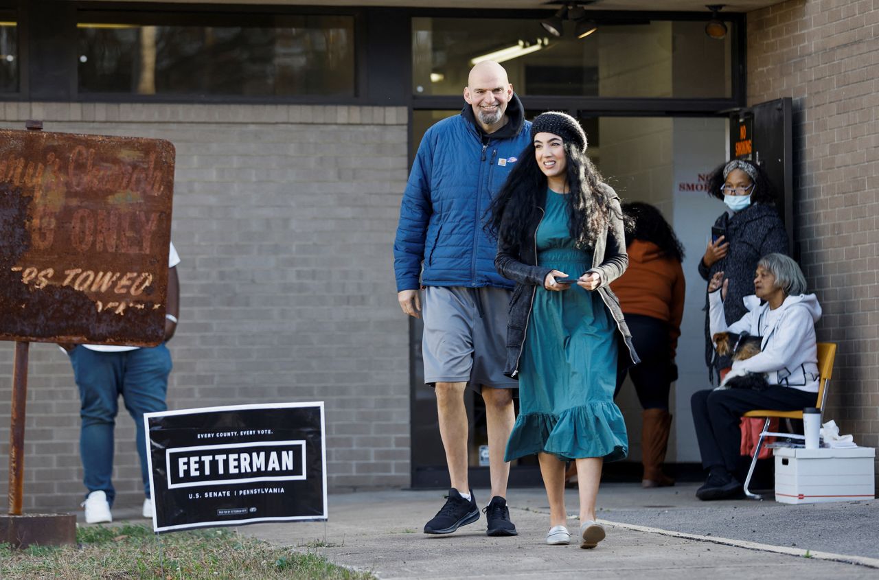 John Fetterman and his wife Gisele Fetterman walk outside a polling location in Braddock in Pittsburgh, Pennsylvania, on November 8.