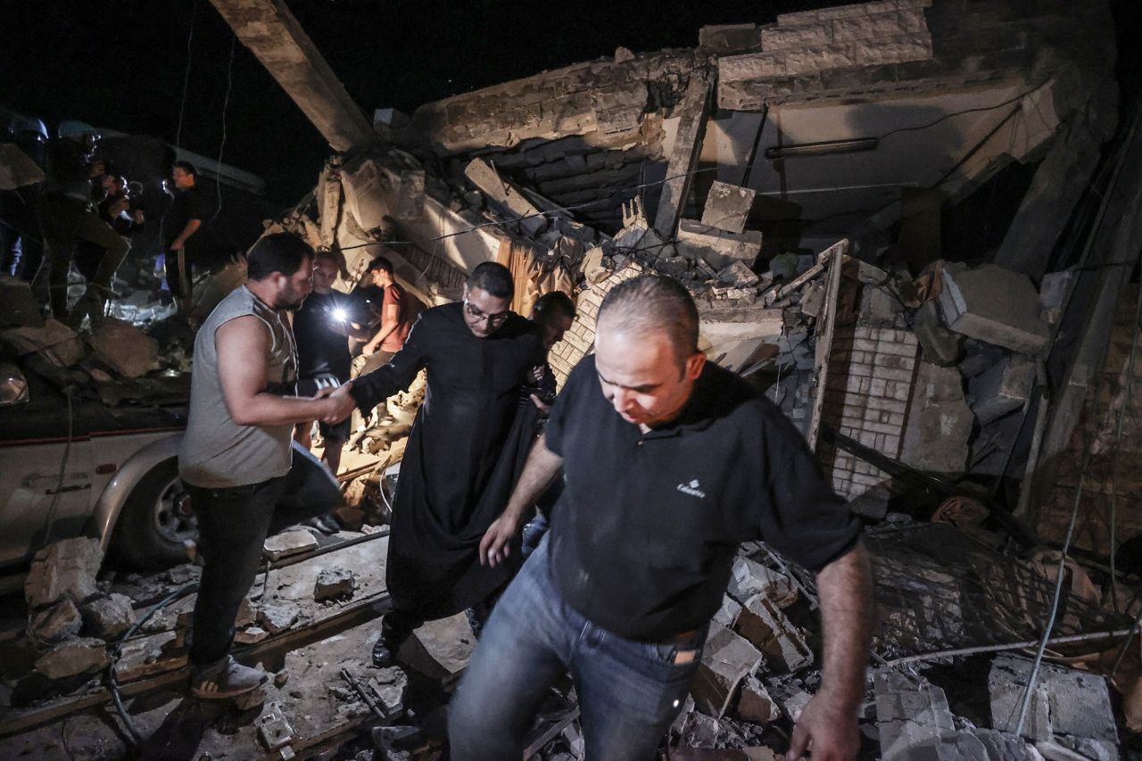 People at the site of an Israeli attack on the Greek Orthodox Church in Gaza City, Gaza, on October 20.