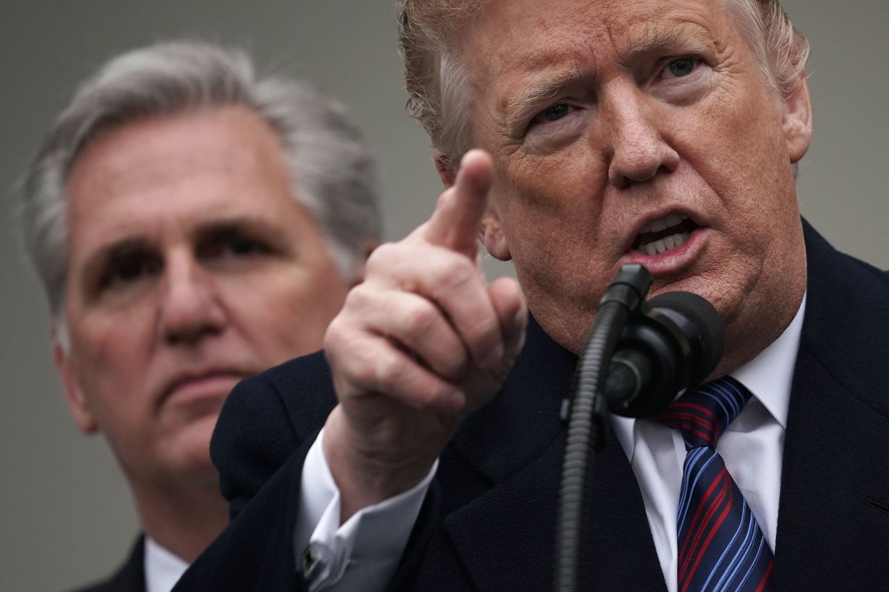 President Donald Trump speaks in the Rose Garden of the White House while Rep. Kevin McCarthy listens in 2019.