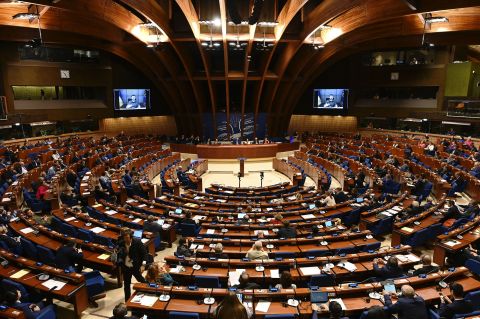 Ukrainian President Volodymyr Zelensky is seen on screen as he remotely addresses a speech to the members of the political delegations of the Parliamentary Assembly of the Council of Europe, in Strasbourg, France, on October 13. 