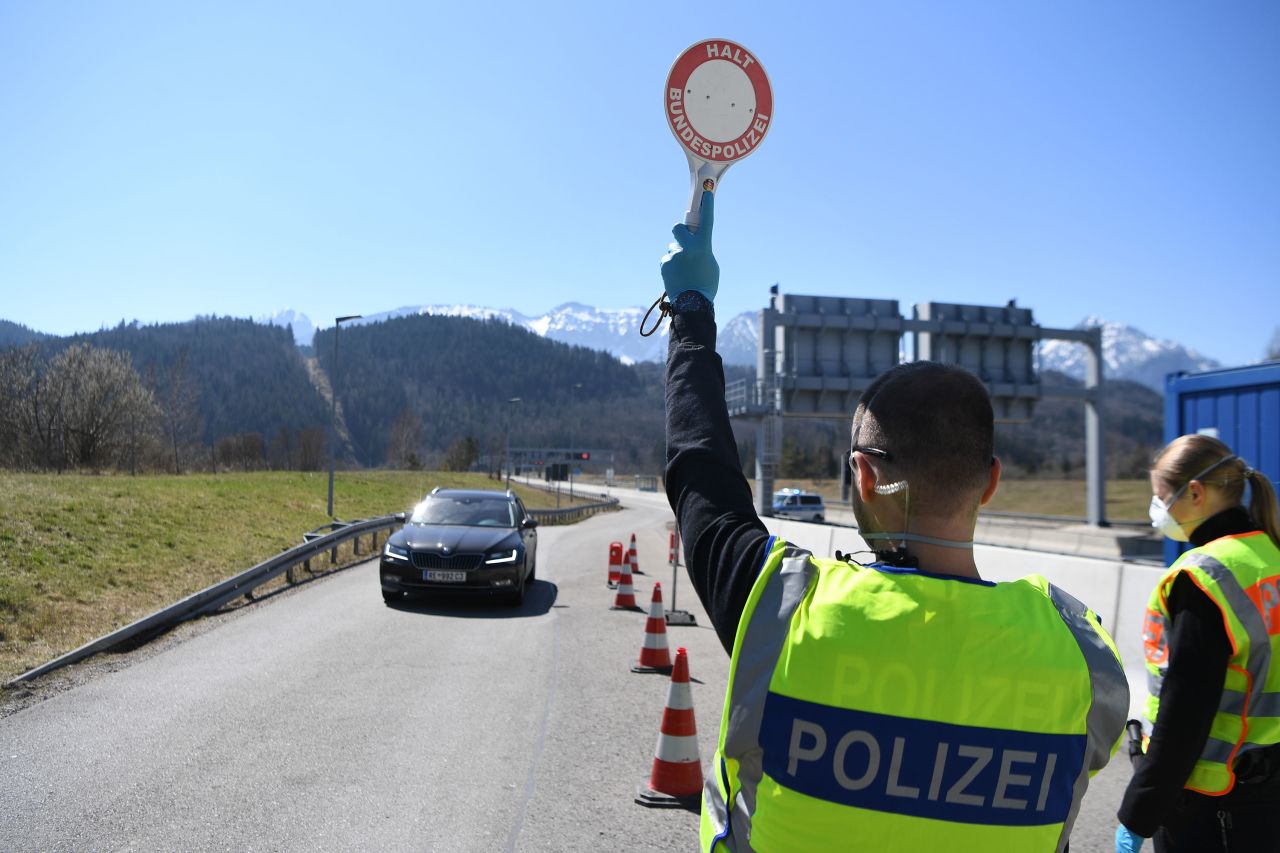 A German police officer stops a car at a checkpoint at the border to Austria near Fussen, Germany, on April 5.