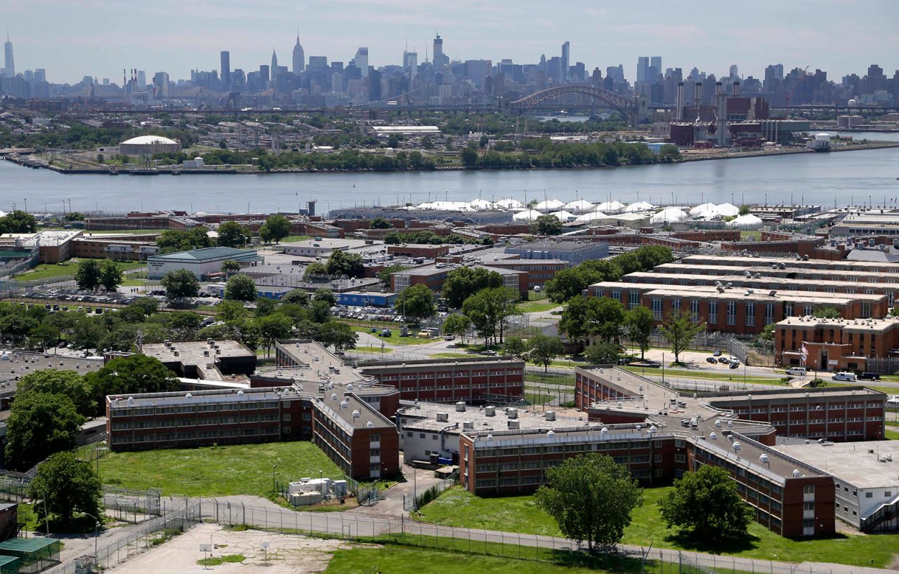 In a June 20, 2014 file photo, the Rikers Island jail complex stands in New York with the Manhattan skyline in the background.