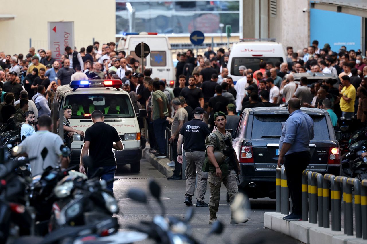 Ambulances are surrounded by people at the entrance of the American University of Beirut Medical Center, on September 17, after explosions hit locations in several Hezbollah strongholds around Lebanon.