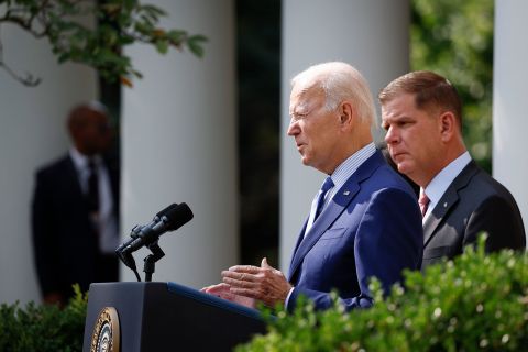 President Joe Biden speaks during an event in the Rose Garden of the White House alongside Labor Secretary Marty Walsh, right, on September 15 in Washington, DC.