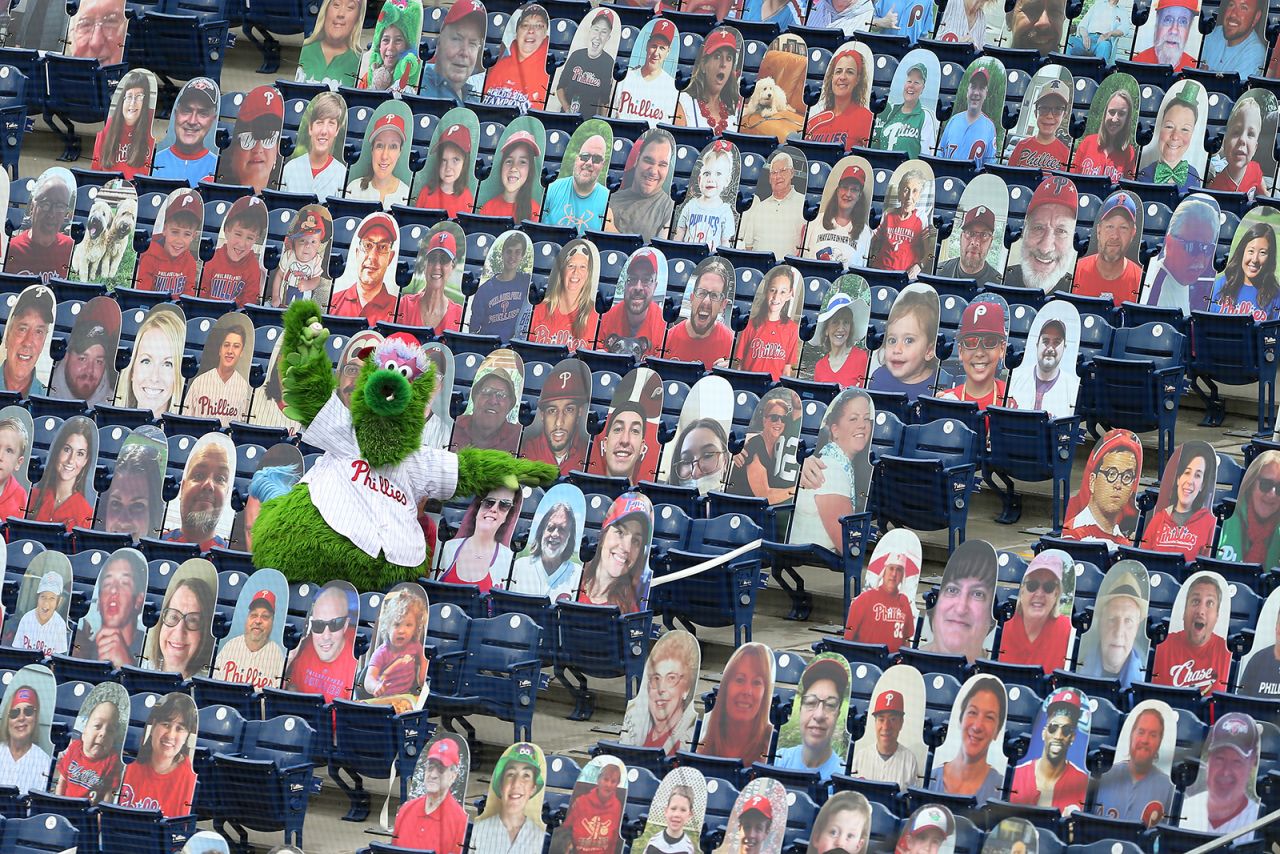 The Phillie Phanatic shows off the foul ball he caught amongst the cardboard cutout fans during an MLB baseball game between the Philadelphia Phillies and New York Mets at Citizens Bank Park on August 16, in Philadelphia, Pennsylvania.