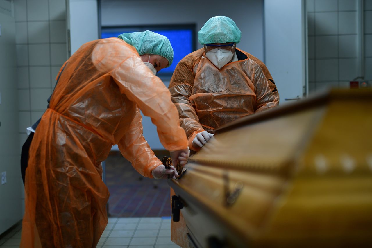 Workers at a funeral home close a coffin with a body of a Covid-19 victim during the second wave of the coronavirus pandemic in Annaberg-Buchholz, Germany on Dec. 7.