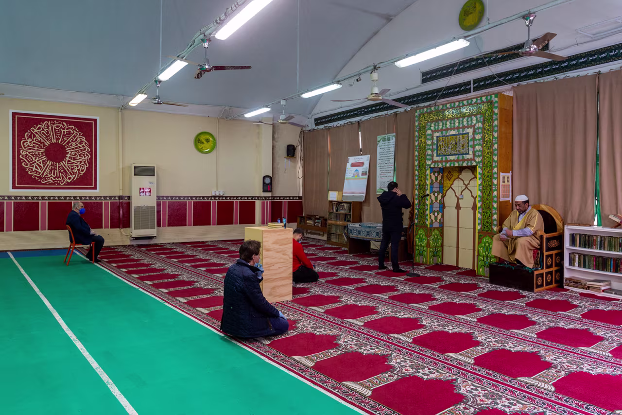 An imam holds the Friday sermon during Ramadan in a near empty mosque in Milan, Italy on May 1.