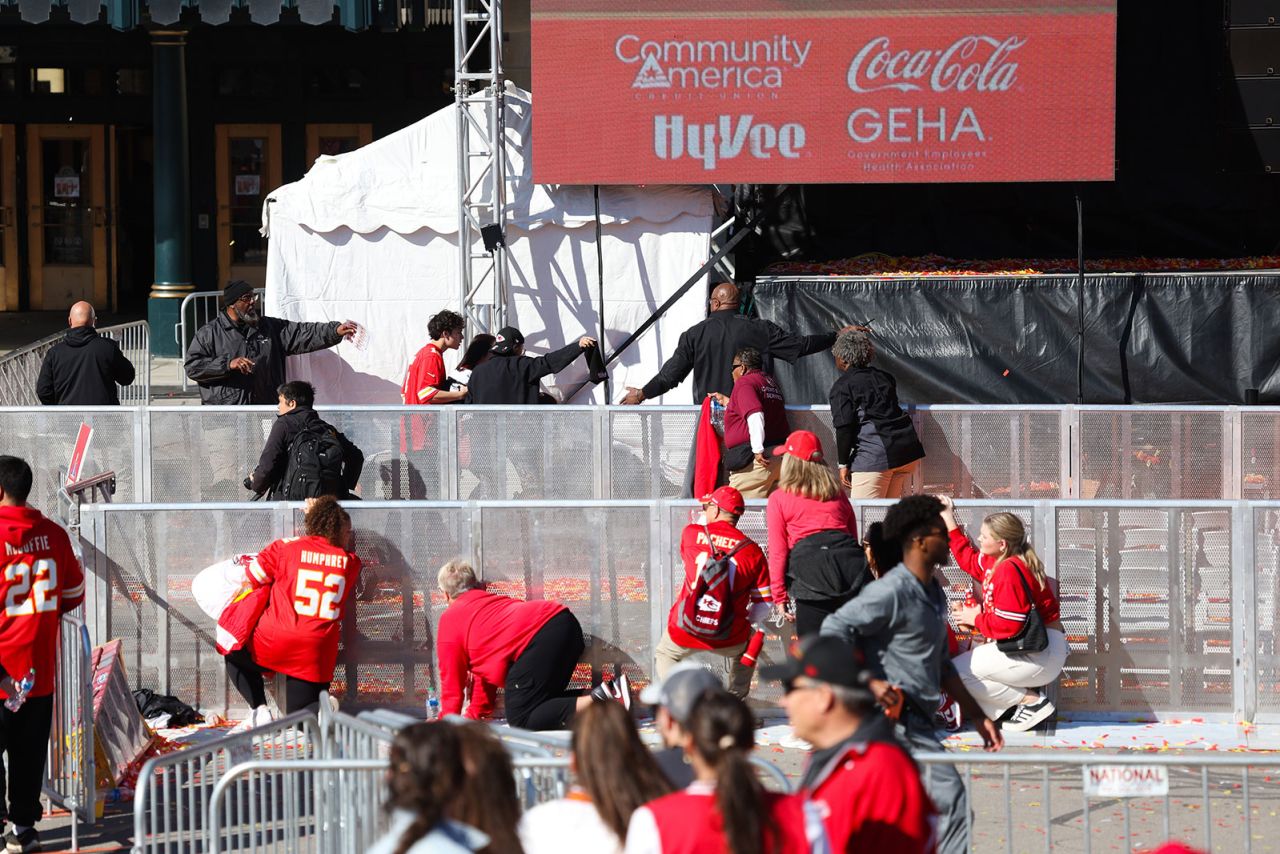 People take cover near the scene of a shooting at Union Station following the Kansas City Chiefs Super Bowl LVIII victory parade on Wednesday in Kansas City.