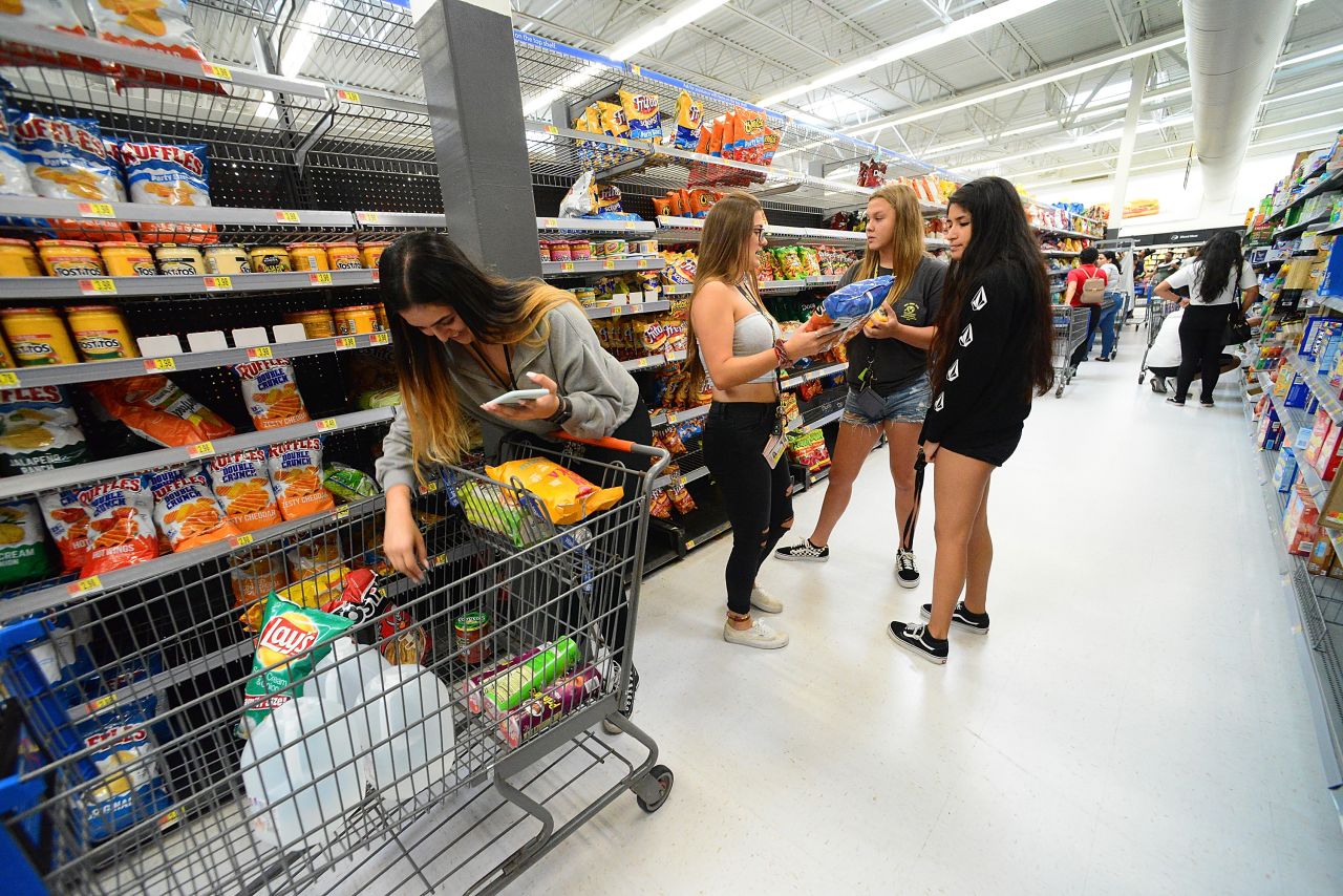 University of Central Florida students buy groceries at a Wal-Mart Super Store in preparation for Hurricane Dorian.