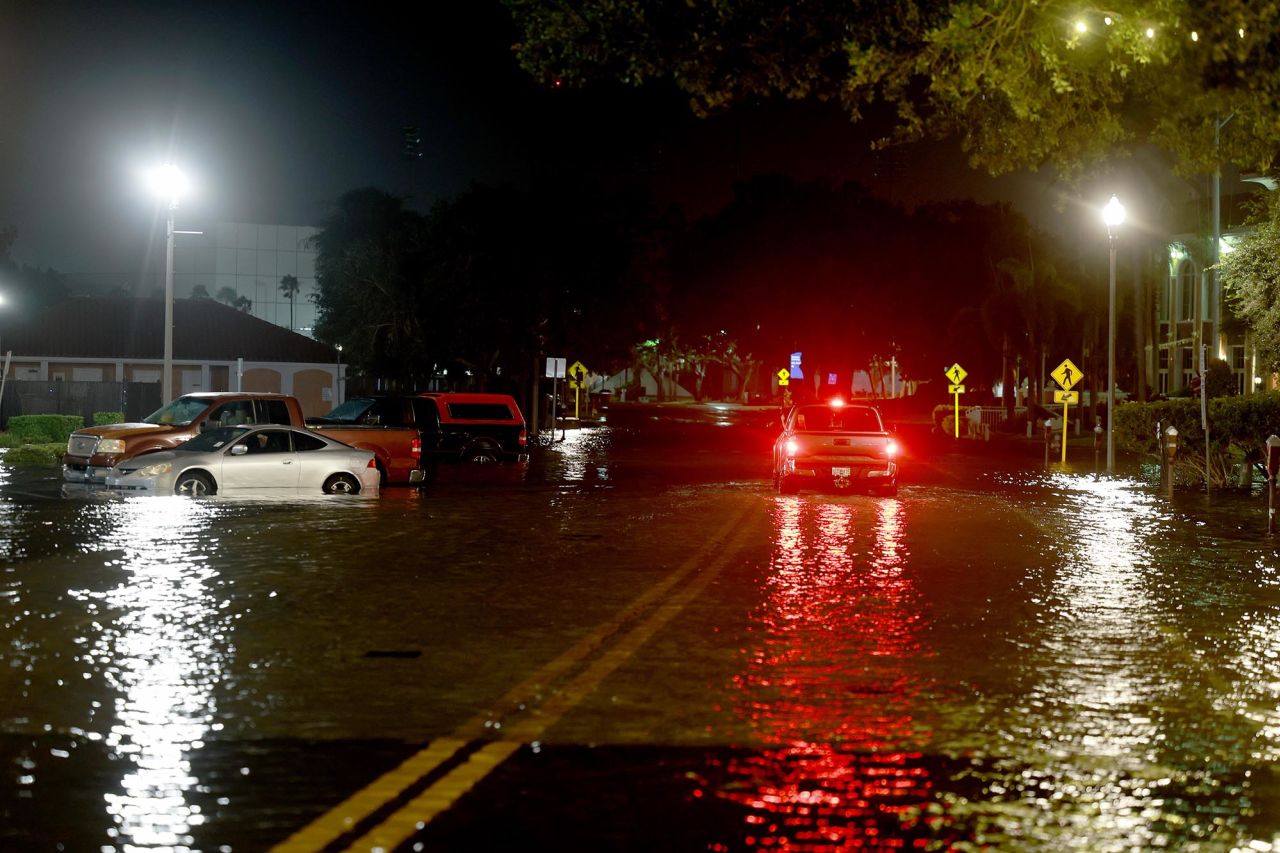 A vehicle drives through flood waters caused by Hurricane Idalia passing offshore on August 30, in St. Petersburg, Florida. 