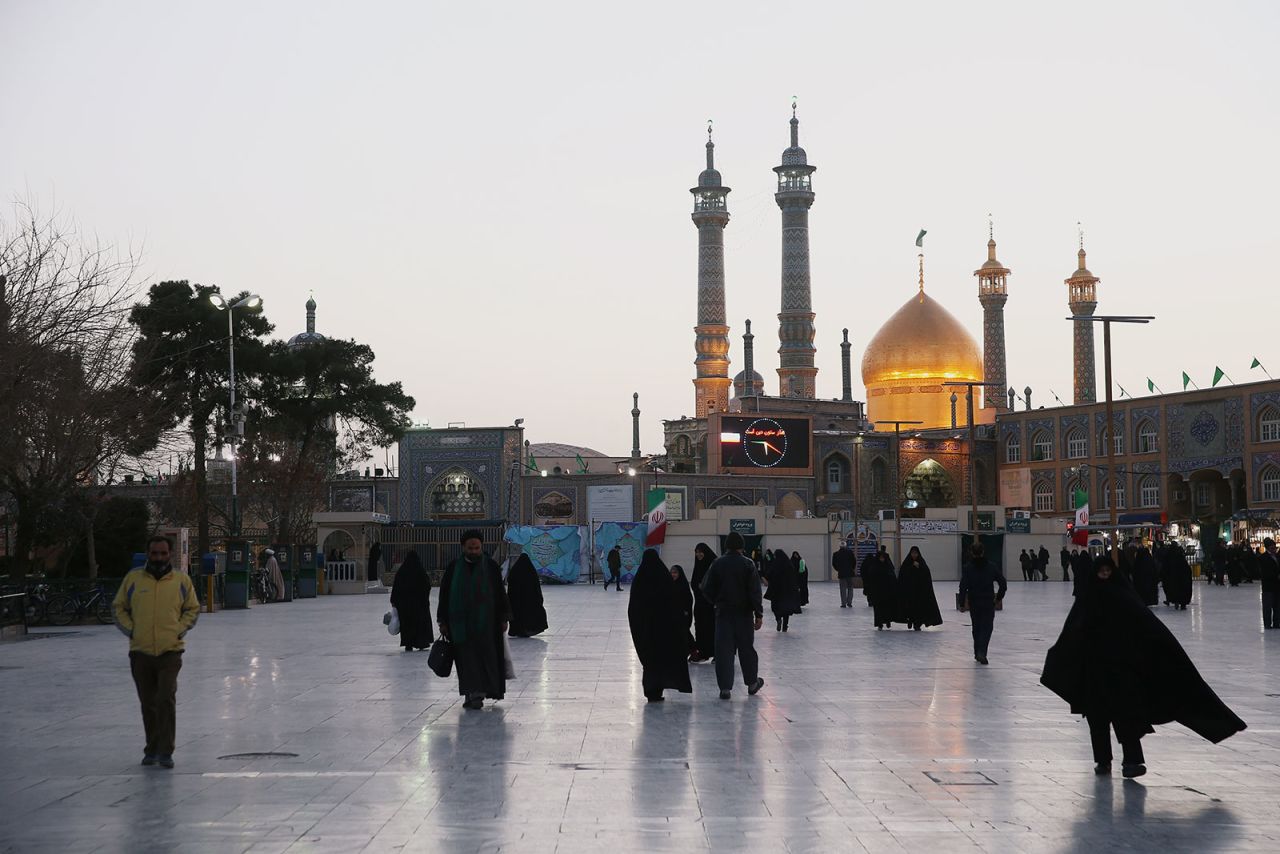 People walk in front of the Shrine of Fatima Masumeh in Qom, Iran on February 9.