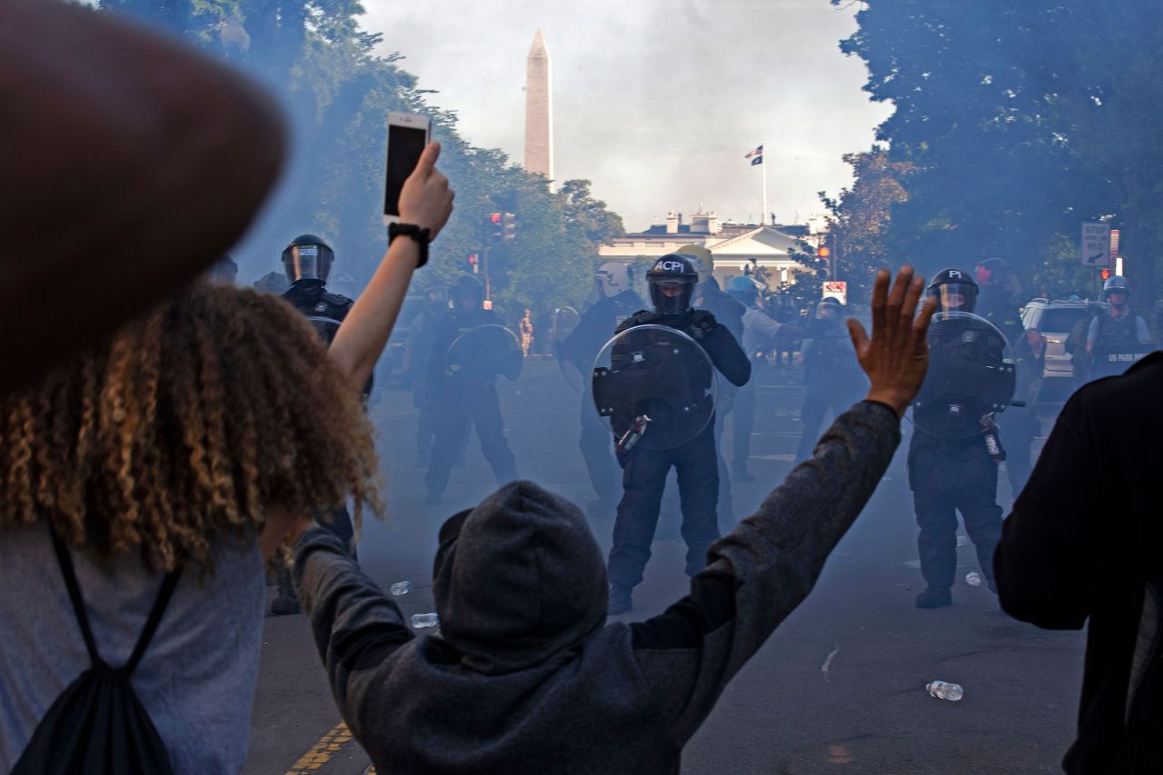 Police officers wearing riot gear push back demonstrators?near the White House in Washington on June 1.