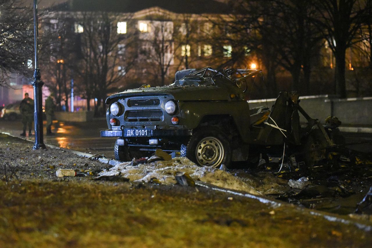 The remains of a military vehicle following an explosion is seen in a parking lot outside a government building in central Donetsk, Ukraine, on February 18. 