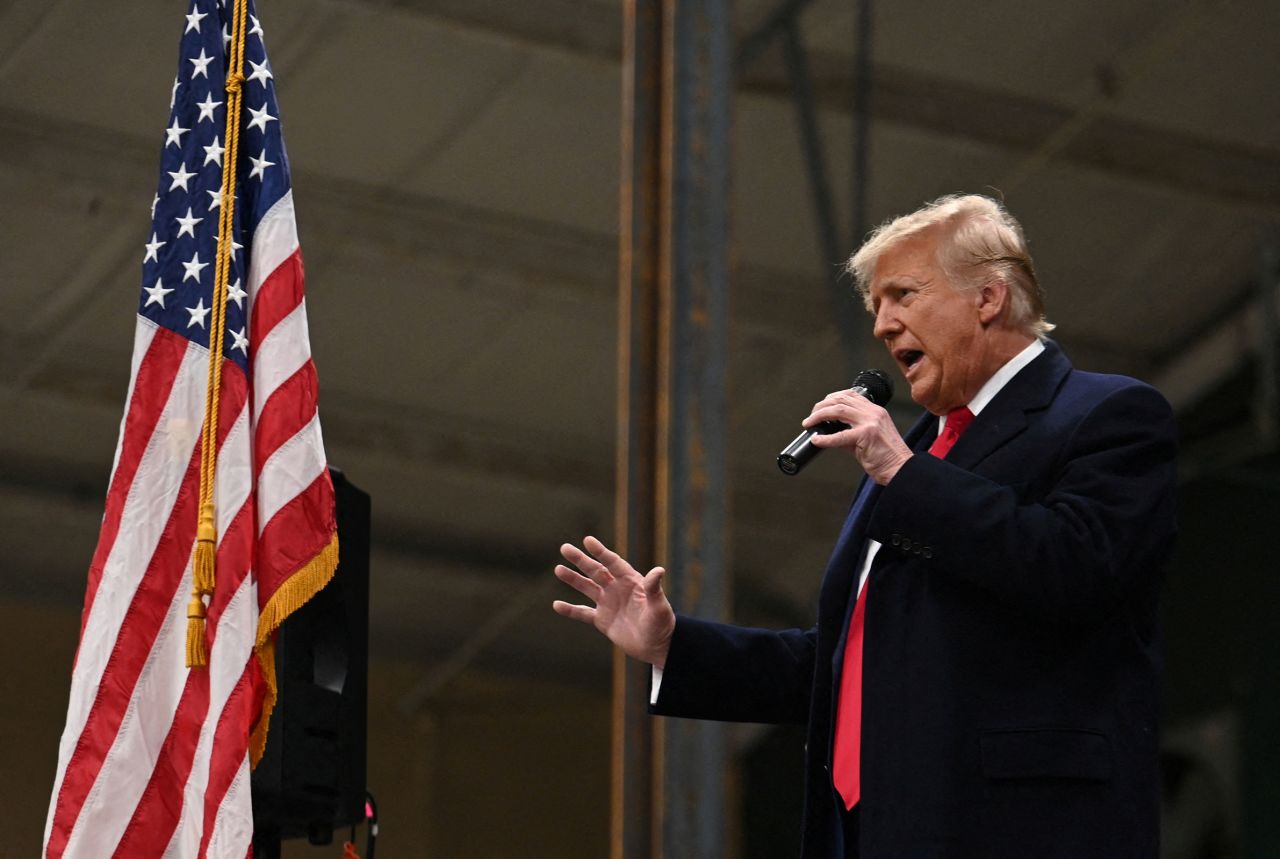 Former President Donald Trump speaks as he visits a caucus site at Horizon Event Center in Clive on Monday.