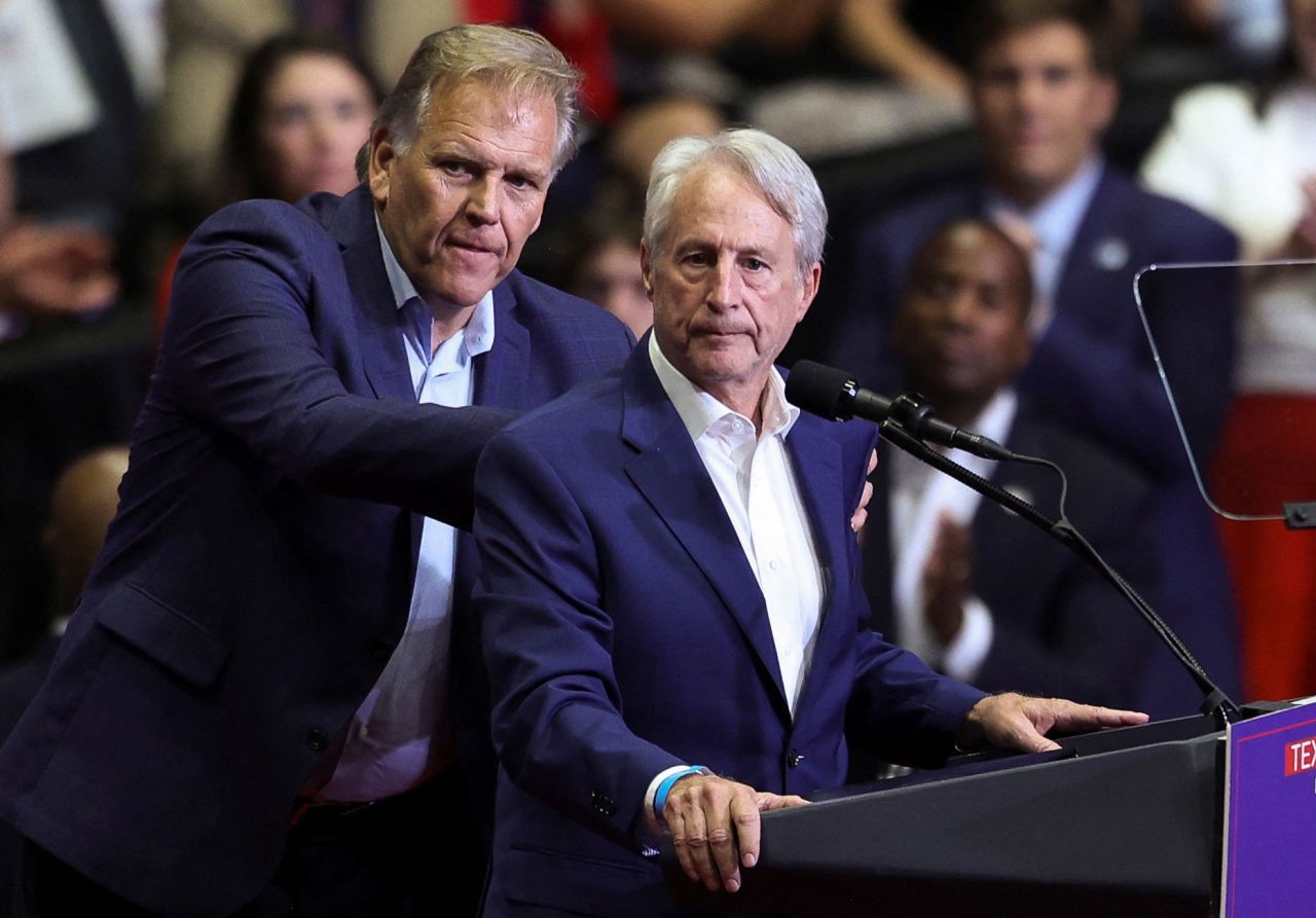 Sandy Pensler, right, and Mike Rogers stand on stage during a campaign rally for former President Donald Trump in Grand Rapids, Michigan, on July 20. 