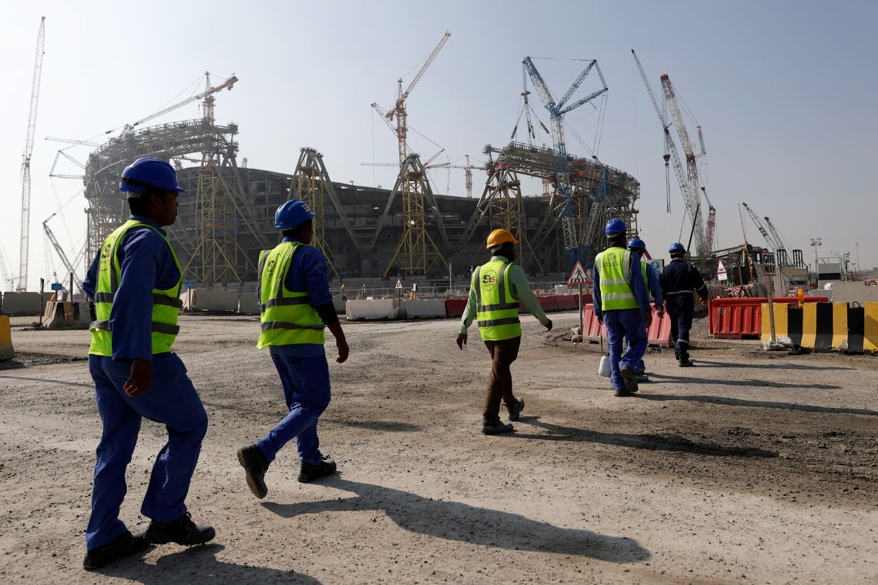 Workers walk to the Lusail Stadium, one of the 2022 World Cup stadiums, in Lusail, Qatar, on December 20, 2019.
