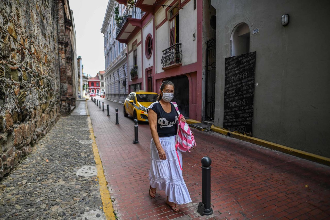 A woman wearing a face mask as a precautionary measure against the spread the coronavirus walks in downtown Panama City on March 17.