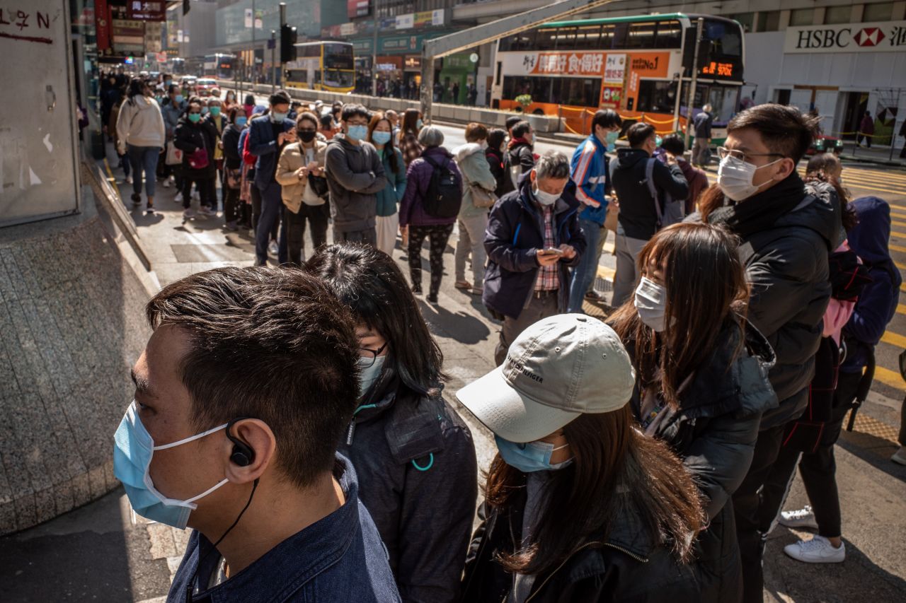 Hong Kong residents line up to buy face mask at a pharmacy on January 31, 2020.