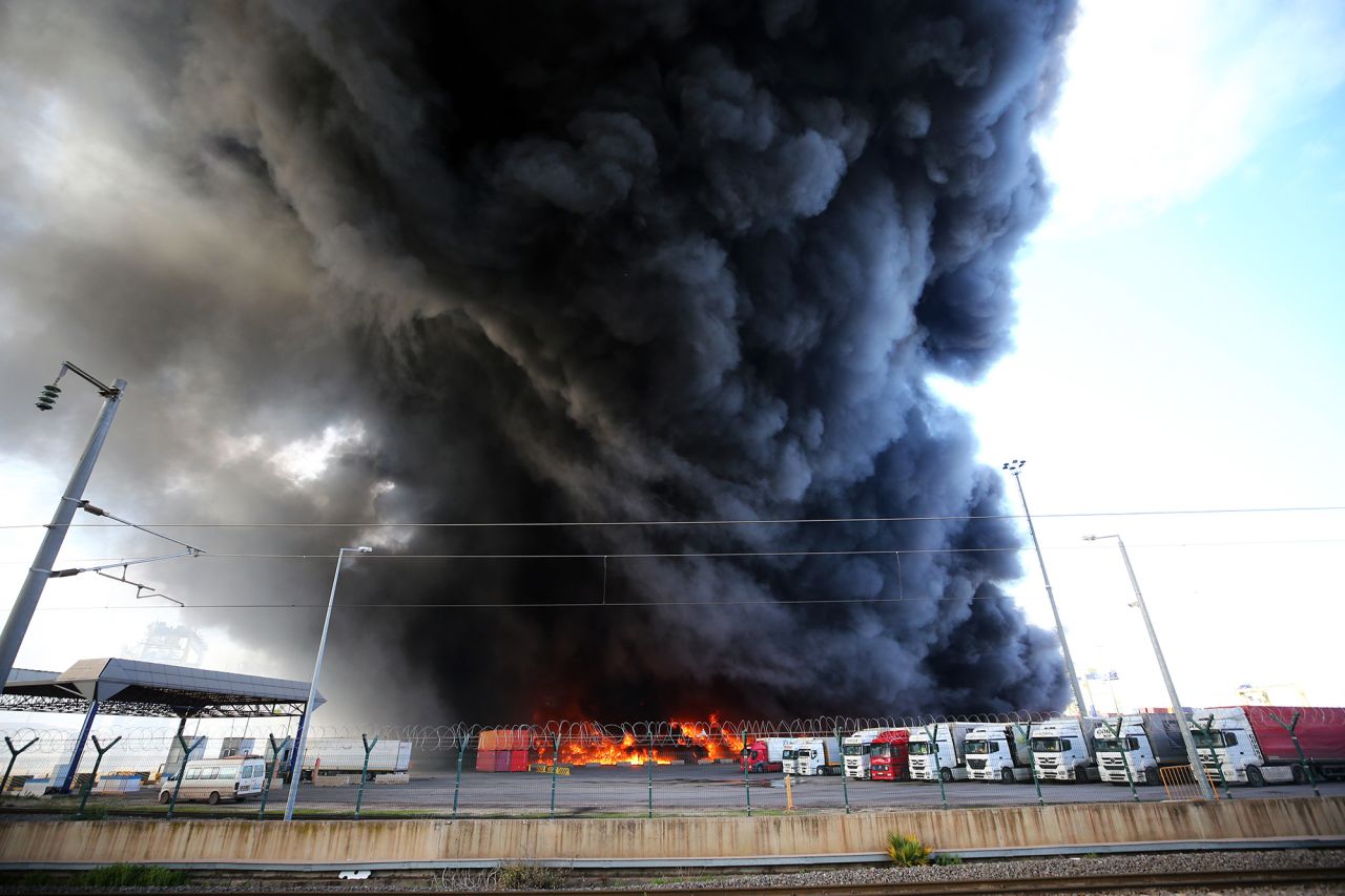 A fire burns in shipping containers that overturned at the Iskenderun Port in Hatay, Turkey, on February 7.