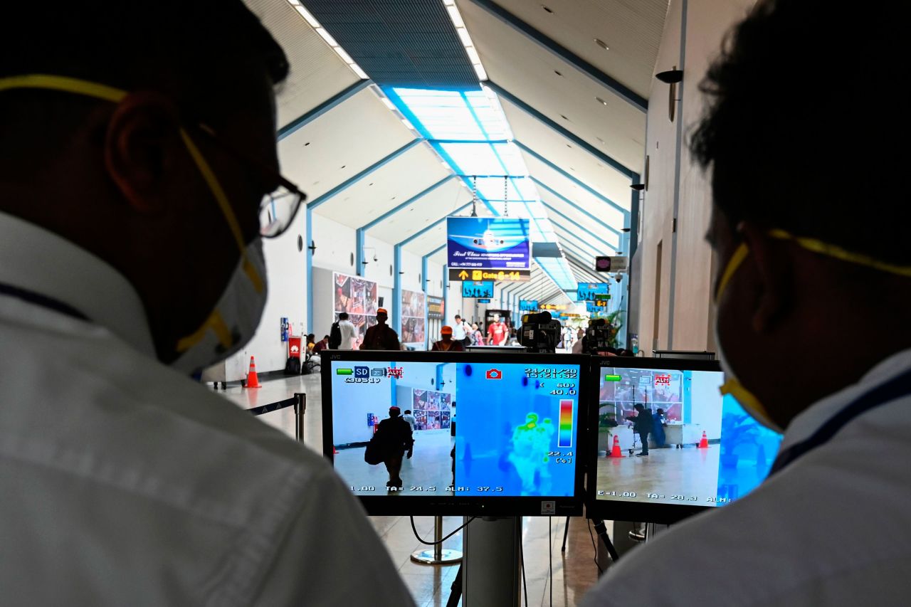 Airport employees monitor screens of a thermal scanner to check body temperature of arriving passengers, at Bandaranaike International airport in Katunayake, Sri Lanka on January 24.