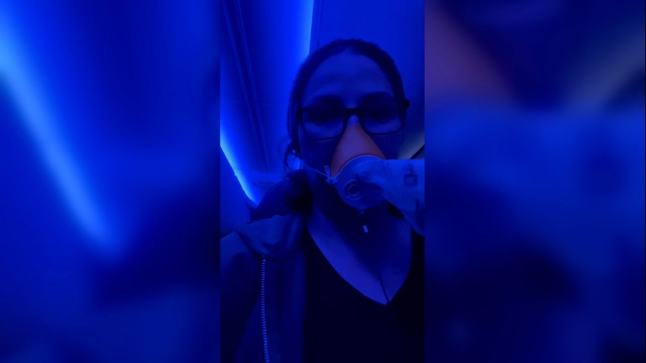 Stephanie King wears an oxygen mask while recording a video aboard her Alaska Airlines flight on Friday. 