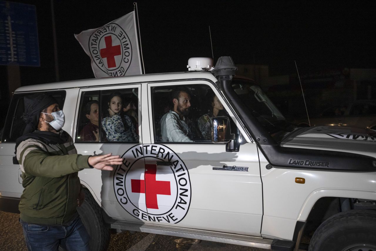 A Red Cross vehicle carrying Israeli hostages enters the Rafah border crossing on Saturday, November 25.